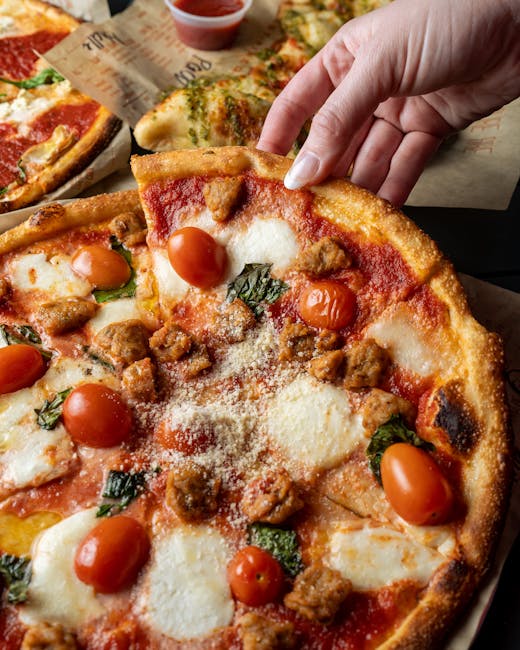 Mouth-watering pizza slice with assorted toppings being lifted by hand. Perfect for food lovers.